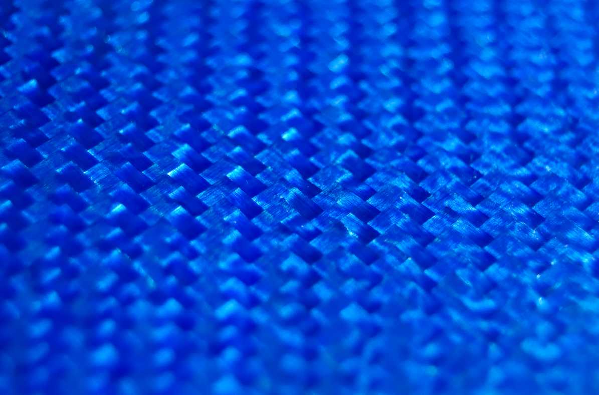 A close-up of the woven texture of a piece of blue Texalium.