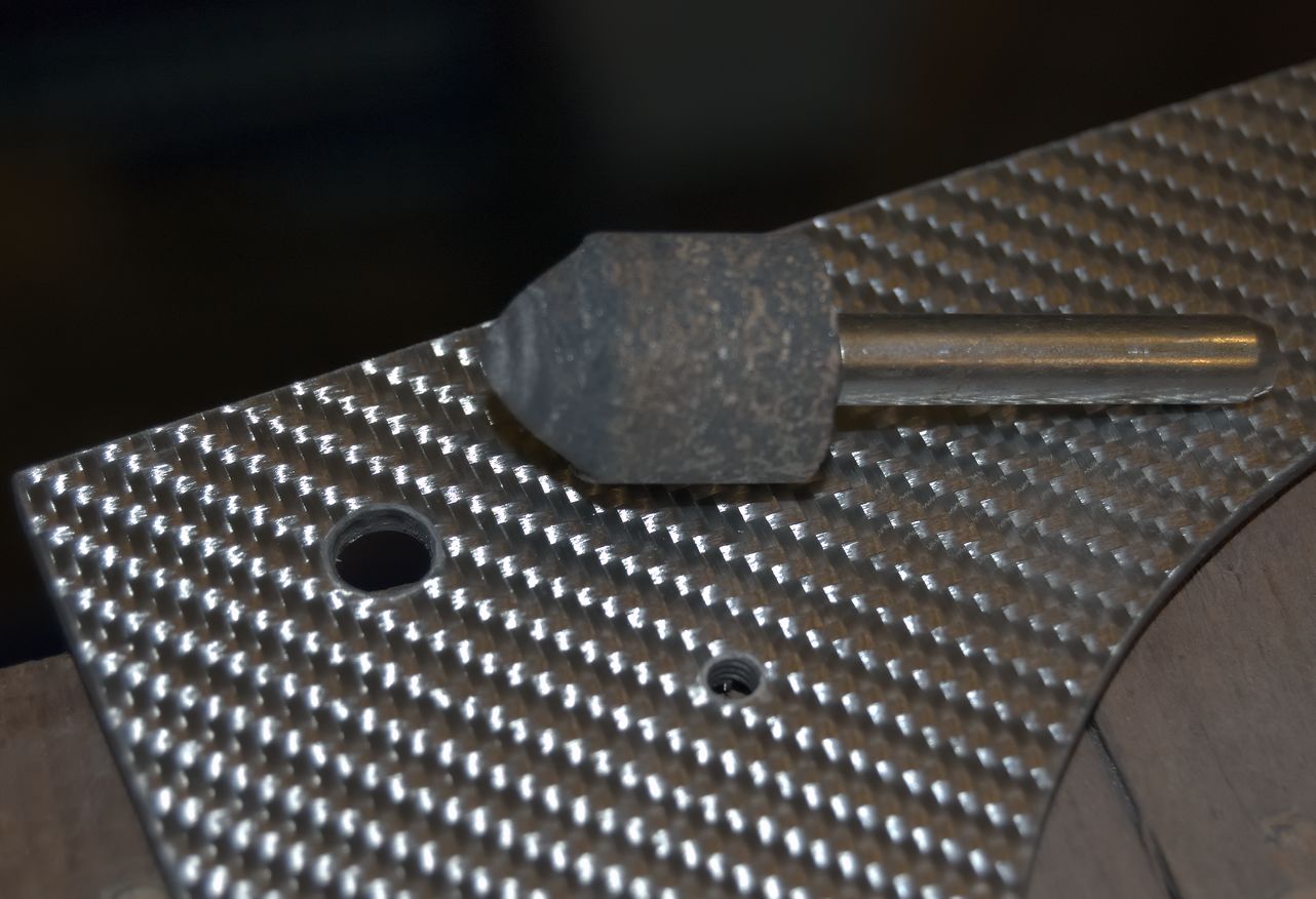 Clean holes in a sheet of carbon fibre.