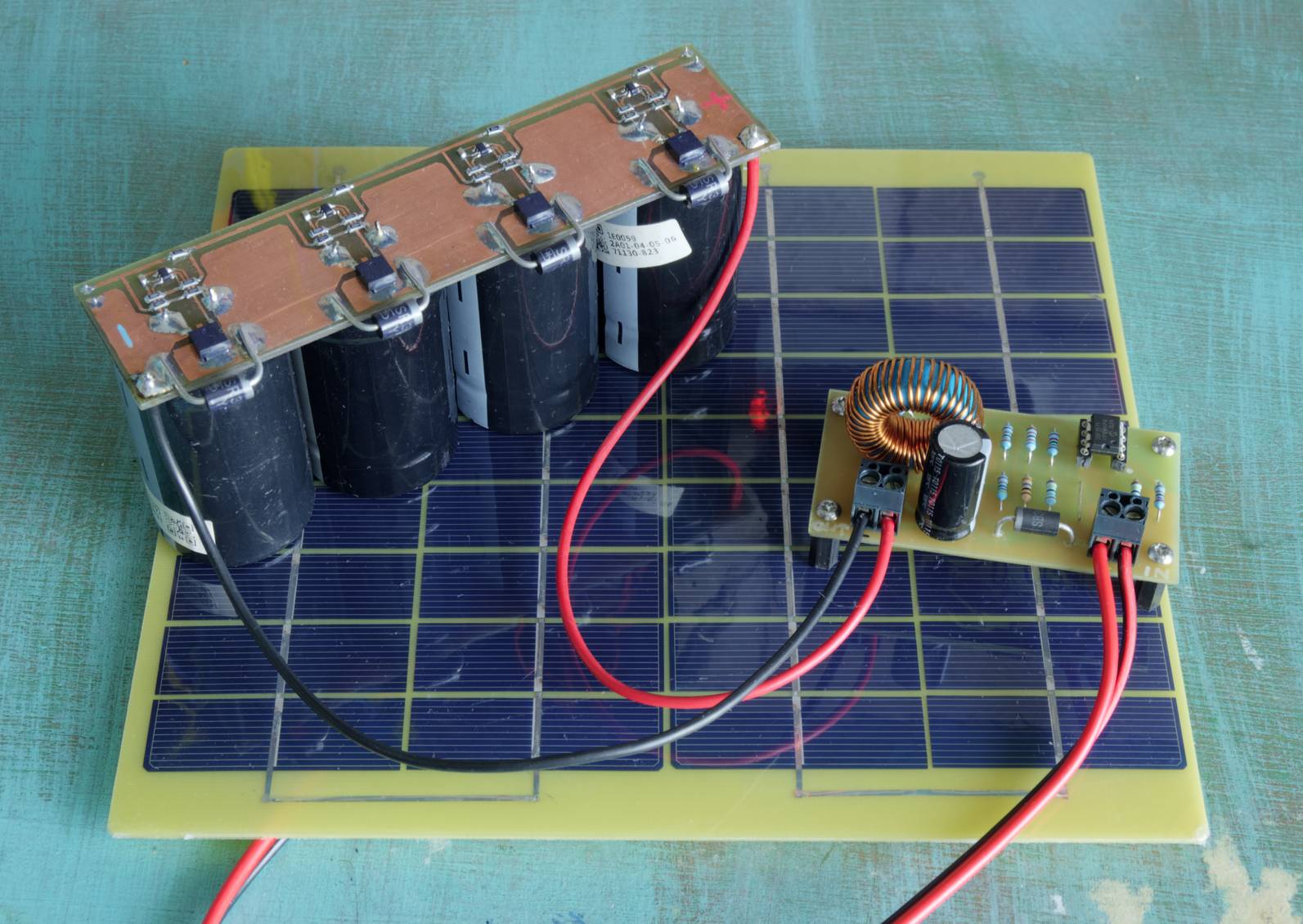 Photo of the PCB connected to the solar panel and supercapacitor bank.