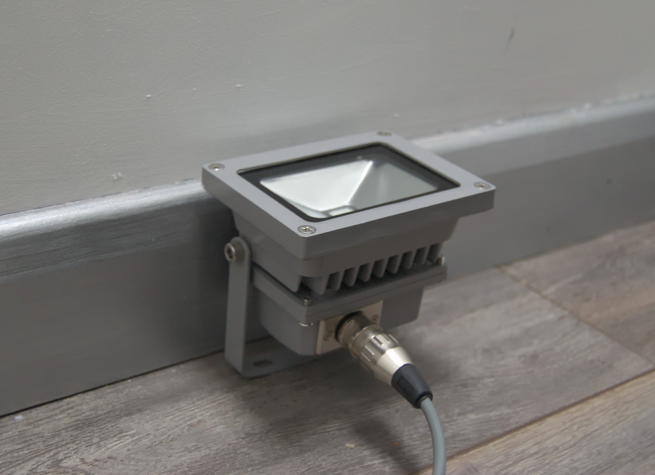 Floodlight mounted on the floor by the wall
